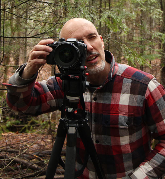 Rob Howard owner of Orbit Creative shooting stock footage with a Panasonic GH5 in the woods of Haliburton Ontario Canada